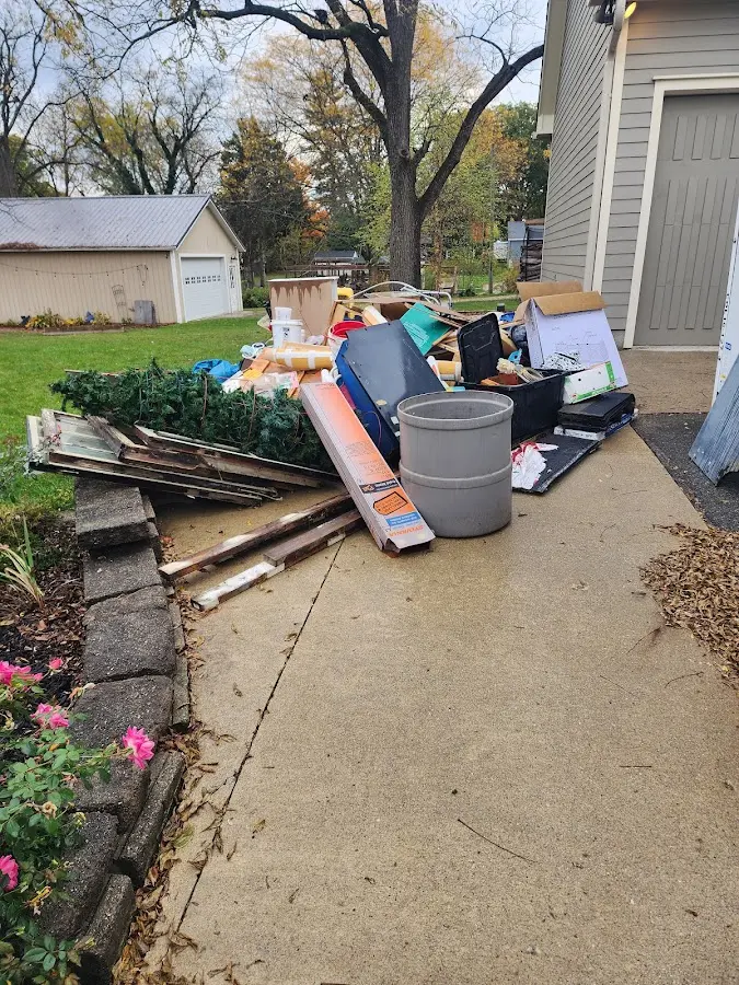 Dumpster being loaded with debris for Roofing Dumpster Rental in Danville